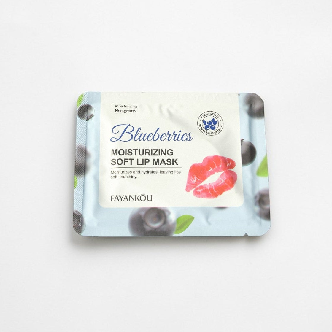 Moisturizing soft lip mask packaging with blueberries on a white background